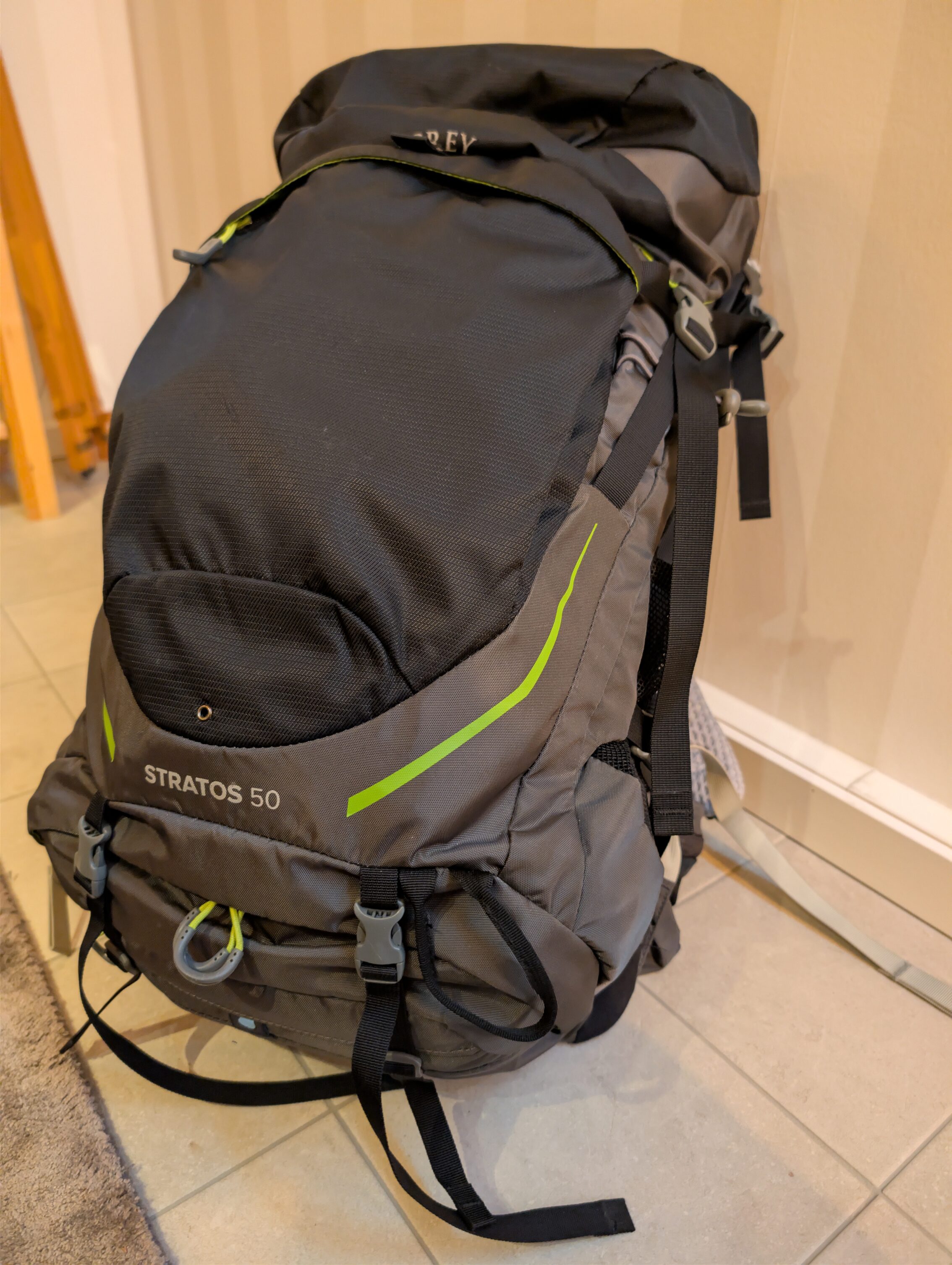 Grey hiking backpack with lime green highlights.