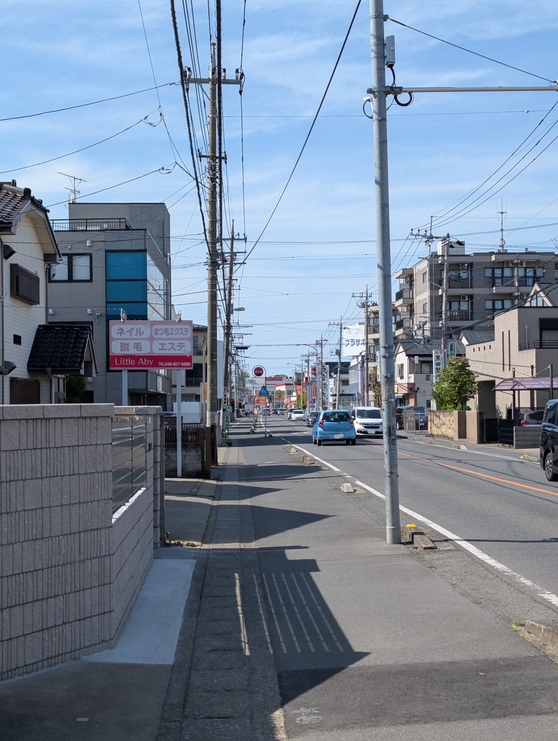 A street view with cars, houses, and office buildings.