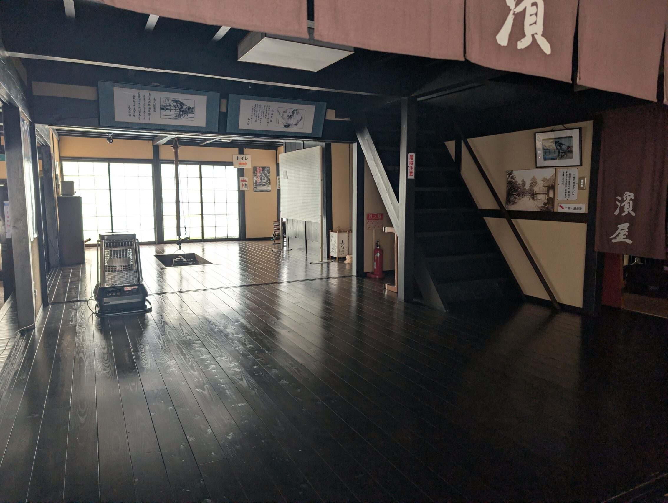 The inside of a honjin, with dark wooden floor.