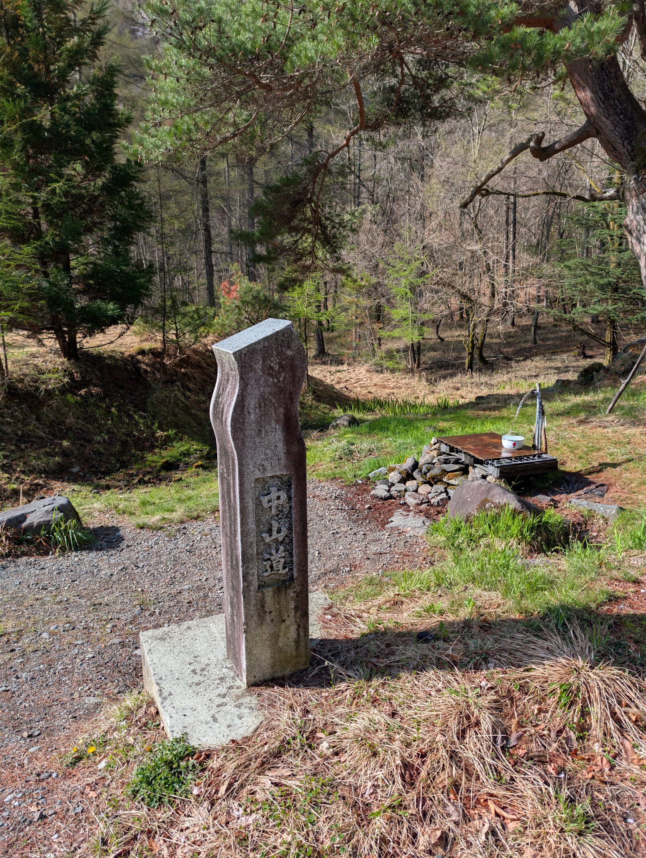 A stone marker for the Nakasendō, and a water spring.