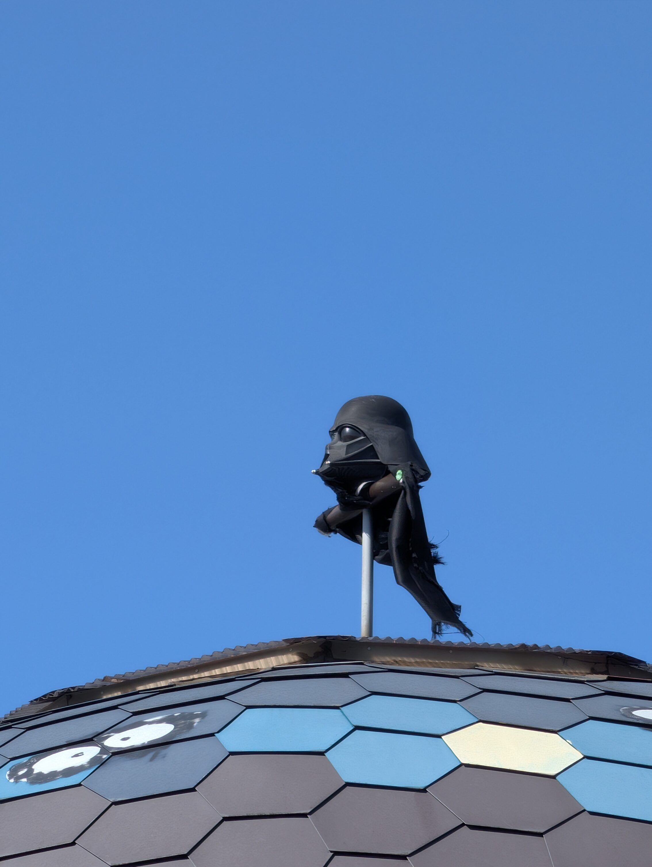 The top of a domed building, with a Darth Vader-themed weather vane.