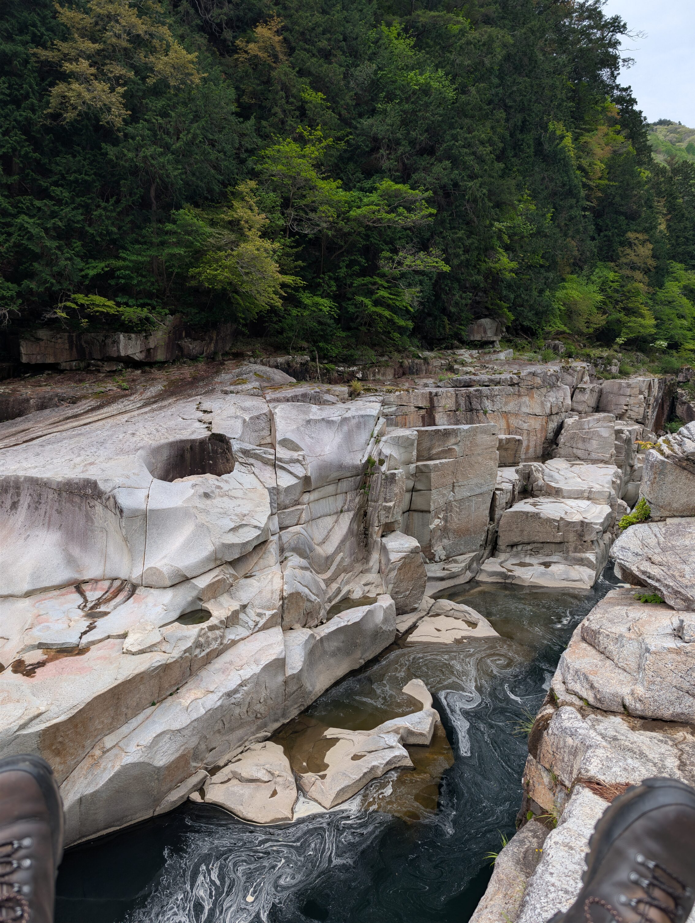 Closer to the narrowest part of the gorge, with a pair of boots visible.