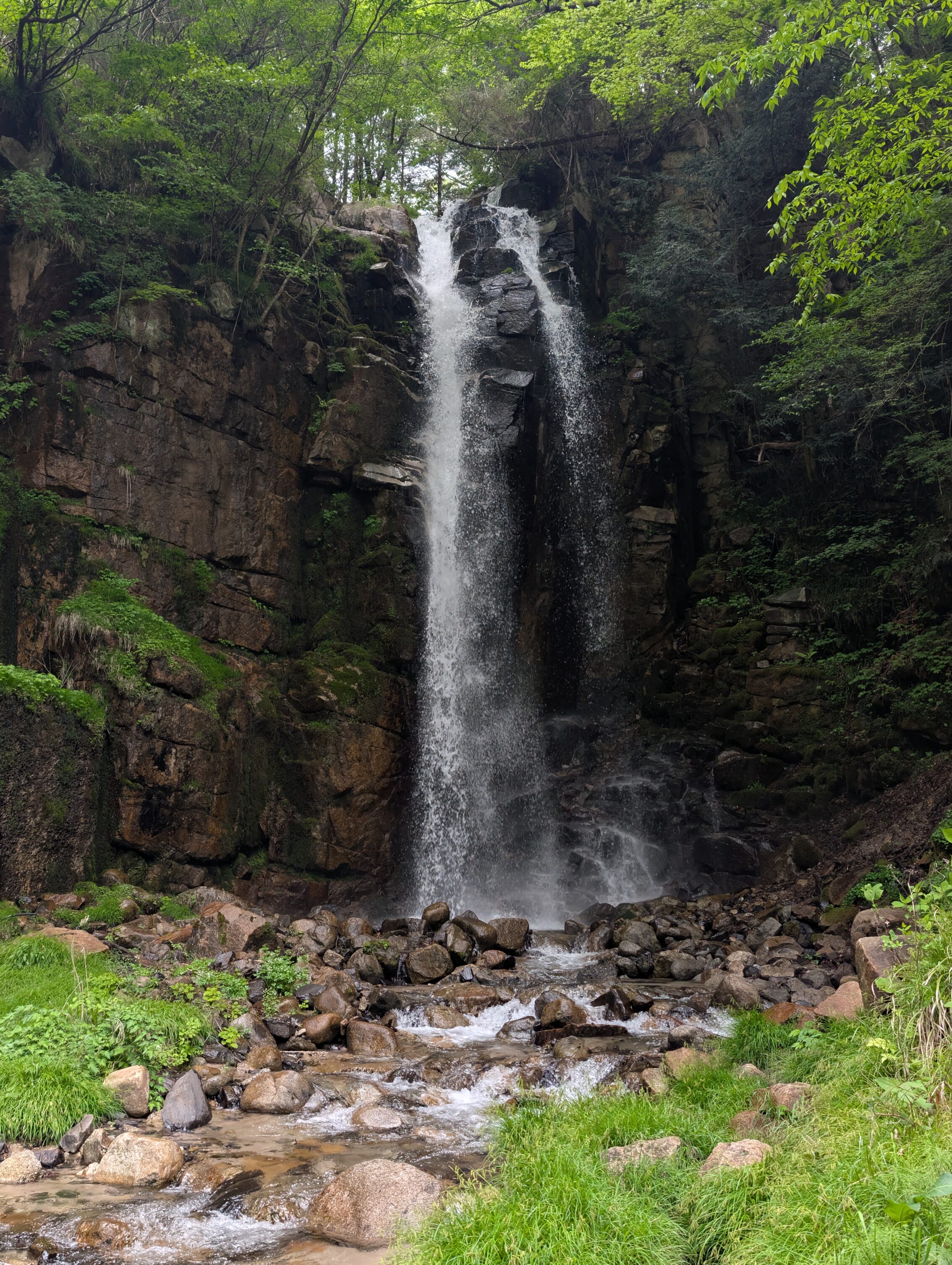 A waterfall streaming down a cliff face.