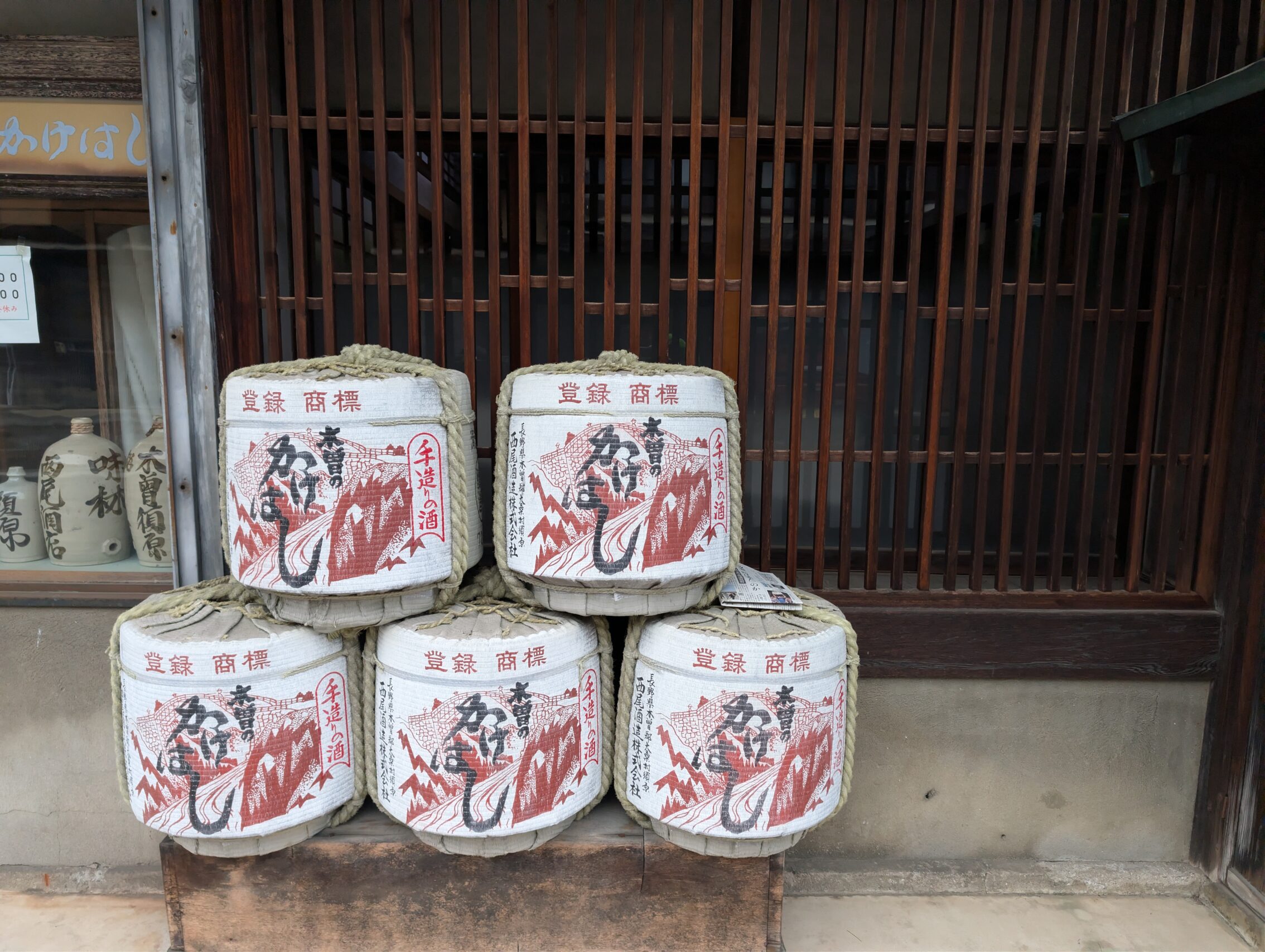 Five sake barrels outside an old building.