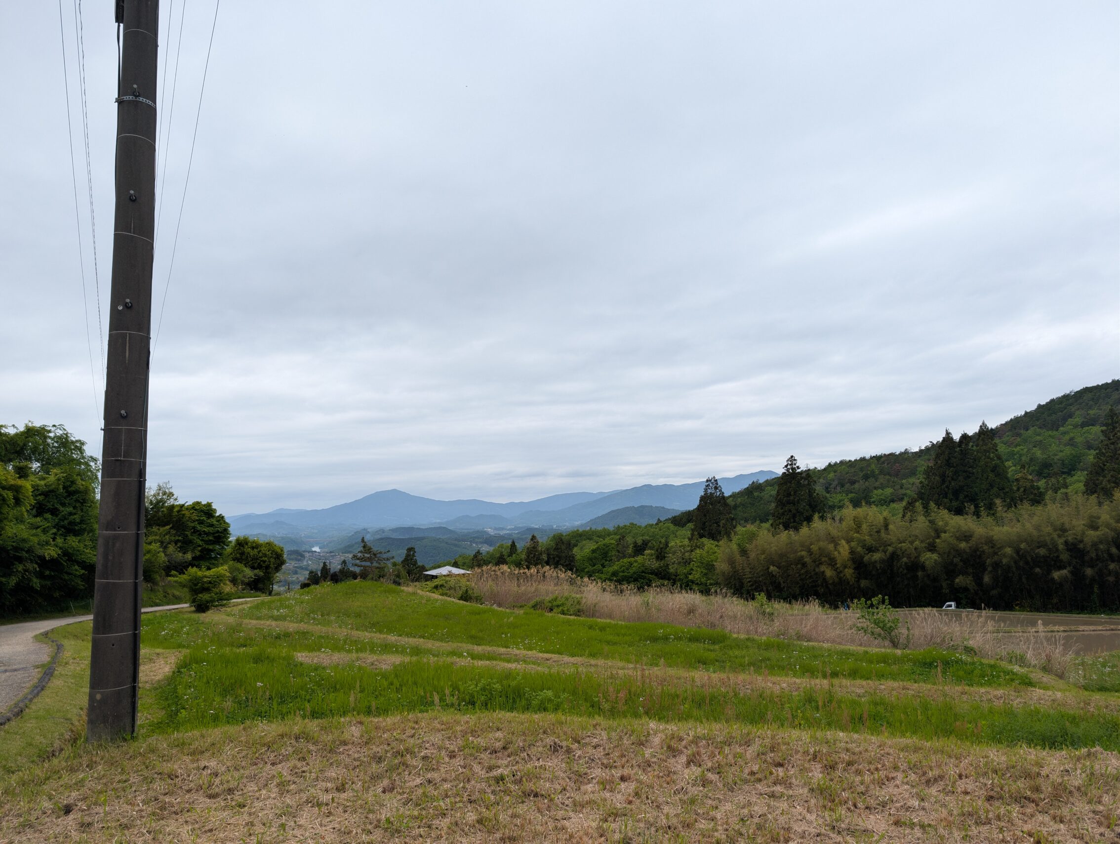 A view of hills in the distance, with grey coulds above.