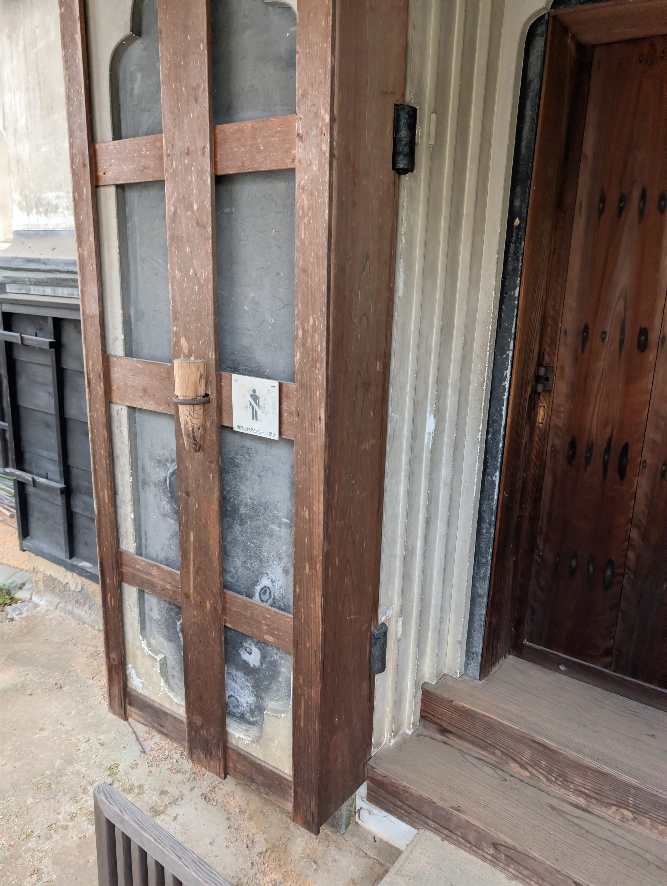 A stone door with a wooden scaffolding to protect it from the elements.